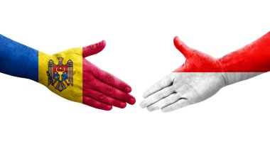 Ellere boyanmış Endonezya ve Moldova bayrakları arasındaki el sıkışma, izole şeffaf görüntü.