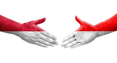 Ellere boyanmış Endonezya ve Monako bayrakları arasındaki el sıkışma, izole şeffaf görüntü.