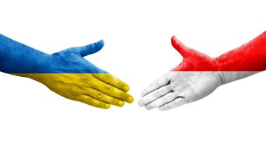 Ellerinde Endonezya ve Ukrayna bayrakları arasında el sıkışma, izole şeffaf görüntü.