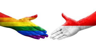 Ellere boyanmış Endonezya ve LGBT bayrakları arasındaki el sıkışma, izole şeffaf resim.