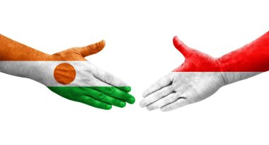 Ellerinde Endonezya ve Nijer bayrakları arasında el sıkışma, izole şeffaf görüntü.