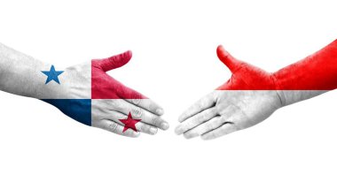 Ellere boyanmış Endonezya ve Panama bayrakları arasındaki el sıkışma, izole şeffaf görüntü.