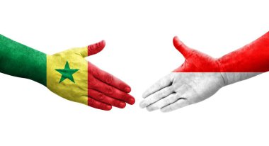 Ellerinde Endonezya ve Senegal bayrakları arasında el sıkışma, izole saydam görüntü.