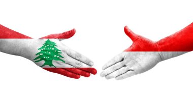 Ellere boyanmış Endonezya ve Lübnan bayrakları arasındaki el sıkışma, izole şeffaf görüntü.