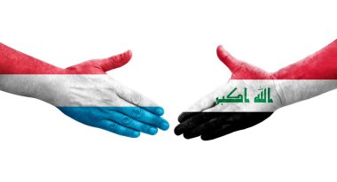 Irak ve Lüksemburg bayrakları arasında el sıkışma, izole şeffaf görüntü.