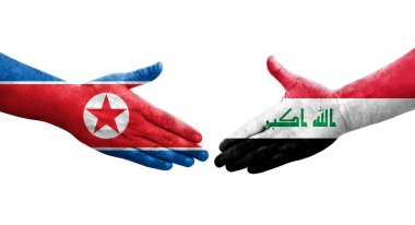 Irak ve Kuzey Kore bayrakları arasında el sıkışma, izole şeffaf görüntü.