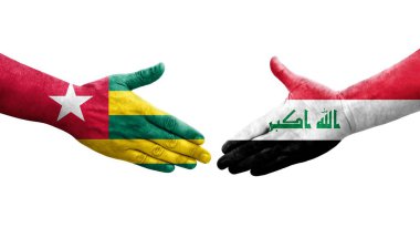 Irak ve Togo bayrakları arasında el sıkışma, izole şeffaf görüntü.