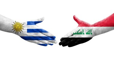 Irak ve Uruguay bayrakları arasında el sıkışma, izole şeffaf görüntü.
