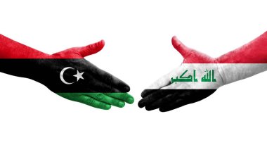 Irak ve Libya bayrakları arasındaki el sıkışma, izole edilmiş şeffaf görüntü.
