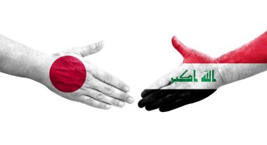 Irak ve Japonya arasındaki el sıkışma ellerinde bayraklar, izole şeffaf görüntü.