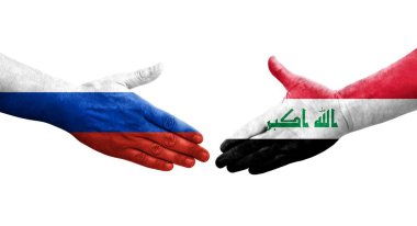 Irak ve Rusya arasındaki el sıkışma ellerinde bayraklar, izole edilmiş şeffaf görüntü.