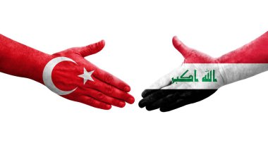 Irak ve Türkiye bayrakları arasında el sıkışma, izole şeffaf görüntü.