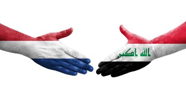 Irak ve Hollanda bayrakları arasında el sıkışma, izole şeffaf görüntü.