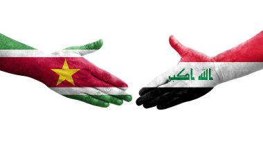 Irak ve Surinam bayrakları arasında el sıkışma, izole saydam görüntü.