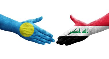 Irak ve Palau bayrakları arasındaki el sıkışma, izole şeffaf görüntü.