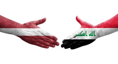 Irak ve Letonya bayrakları arasında el sıkışma, izole şeffaf görüntü.