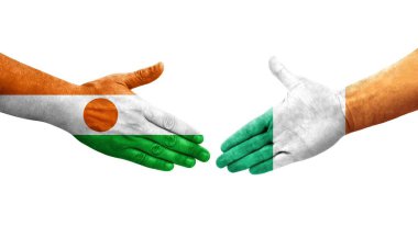 İrlanda ve Nijer bayrakları arasında el sıkışma, izole şeffaf görüntü.