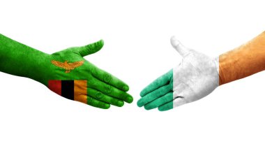 İrlanda ve Zambiya bayrakları arasında el sıkışma, izole şeffaf görüntü.