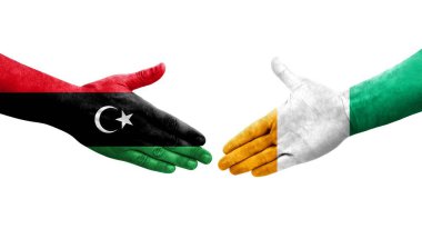 Fildişi Sahili ile Libya bayrakları arasındaki el sıkışma, izole şeffaf görüntü.