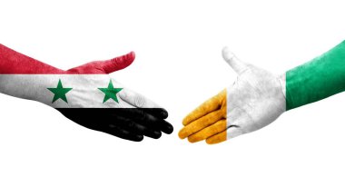 Fildişi Sahilleri ve Suriye bayrakları arasındaki el sıkışma, izole şeffaf görüntü.