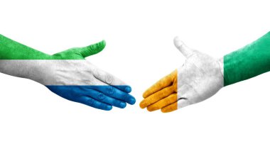 Fildişi Sahilleri ve Sierra Leone bayrakları arasındaki el sıkışma..