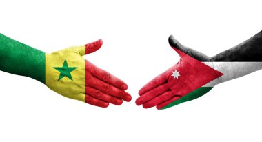 Ürdün ve Senegal bayrakları arasındaki el sıkışma ellere boyanmış, izole şeffaf görüntü.