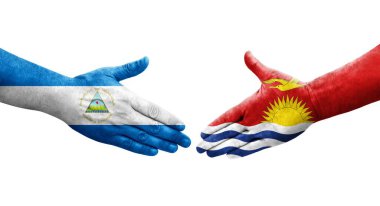 Ellerinde Kiribati ve Nikaragua bayrakları arasında el sıkışma, izole şeffaf görüntü.