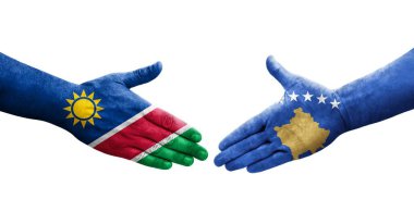 Ellerinde Kosova ile Namibya bayrakları arasında el sıkışma, izole edilmiş şeffaf görüntü.