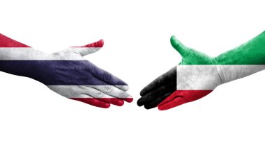 Kuveyt ve Tayland bayrakları arasındaki el sıkışma ellere boyanmış, izole saydam görüntü.