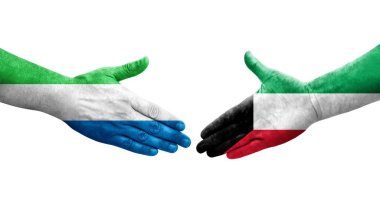 Kuveyt ve Sierra Leone bayrakları arasındaki tokalaşma elleri boyalı, izole şeffaf görüntü.