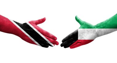 Kuveyt ve Trinidad Tobago bayrakları arasındaki el sıkışma ellerinde izole şeffaf görüntü.