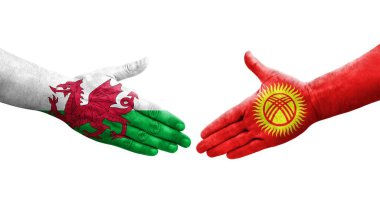 Kırgızistan ve Galler arasındaki el sıkışma ellerinde boyanmış bayraklar, izole şeffaf görüntü.