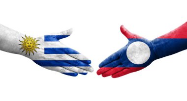 Laos ve Uruguay bayrakları arasındaki el sıkışma ellerinde resmedilmiş şeffaf görüntü.