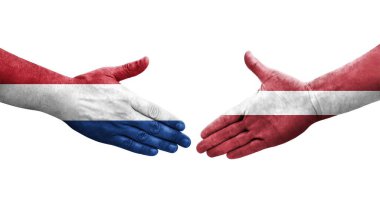 Letonya ve Hollanda bayrakları arasındaki el sıkışma, izole edilmiş şeffaf görüntü.