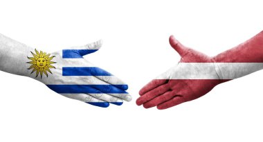 Letonya ve Uruguay bayrakları arasında el sıkışma, izole şeffaf görüntü.