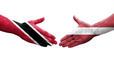 Letonya ve Trinidad Tobago bayrakları arasındaki el sıkışma ellerinde izole şeffaf görüntü.