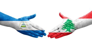 Lübnan ve Nikaragua bayrakları arasındaki el sıkışma ellerinde izole şeffaf görüntü.