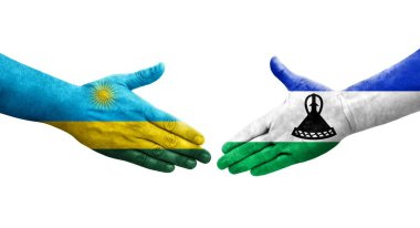 Lesotho ve Ruanda bayrakları arasındaki el sıkışma ellerinde izole şeffaf görüntü.