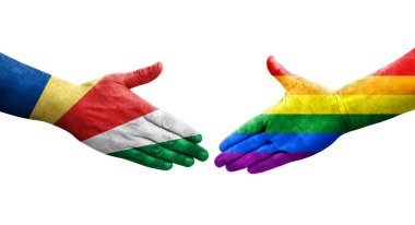 Ellere boyanmış LGBT ve Seyşeller bayrakları arasındaki el sıkışma, izole şeffaf resim.