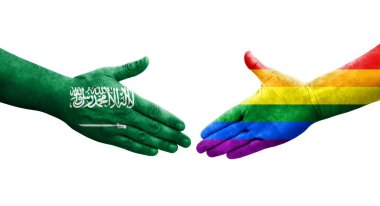 LGBT ve Suudi Arabistan bayrakları arasındaki el sıkışma, izole şeffaf görüntü.