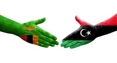 Libya ve Zambiya bayrakları arasındaki el sıkışma, izole edilmiş şeffaf görüntü.