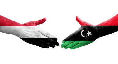 Libya ve Yemen bayrakları arasındaki el sıkışma, izole şeffaf görüntü.