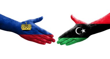 Libya ve Lihtenştayn bayrakları arasındaki el sıkışma, izole şeffaf görüntü.