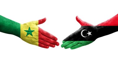 Libya ve Senegal bayrakları arasındaki el sıkışma, izole edilmiş şeffaf görüntü.