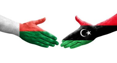 Libya ve Madagaskar bayrakları arasındaki el sıkışma, izole edilmiş şeffaf görüntü.