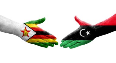 Libya ve Zimbabwe bayrakları arasında el sıkışma, izole şeffaf görüntü.