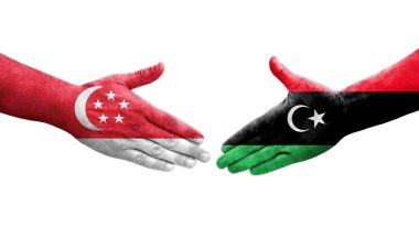 Libya ve Singapur bayrakları arasındaki el sıkışma el yazısı, izole edilmiş şeffaf görüntü.