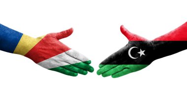 Libya ve Seyşeller arasındaki el sıkışma ellerinde boyanmış bayraklar, izole şeffaf görüntü.