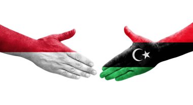 Libya ve Monako bayrakları arasındaki el sıkışma, izole saydam görüntü.