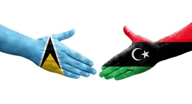 Libya ve Saint Lucia bayrakları arasındaki el sıkışma, izole şeffaf görüntü.